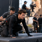 Stunt performer preparing for a controlled film stunt on a professional set
