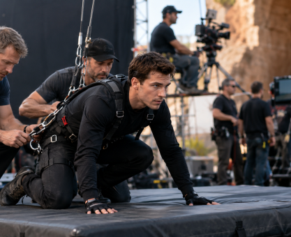 Stunt performer preparing for a controlled film stunt on a professional set